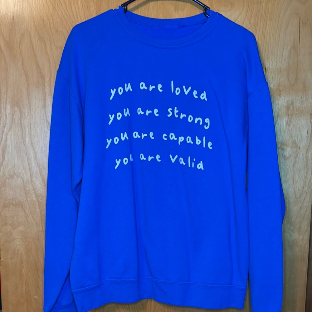 Vibrant Blue Sweatshirt with Empowering Message